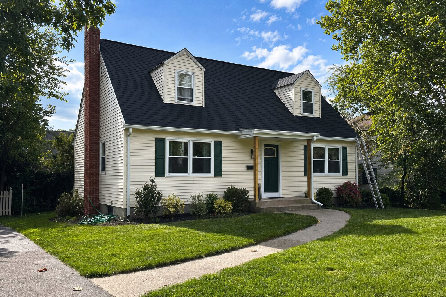 Cape Cod-style home near Drums, PA — asphalt shingle roof freshly soft-washed to remove black algae streaks