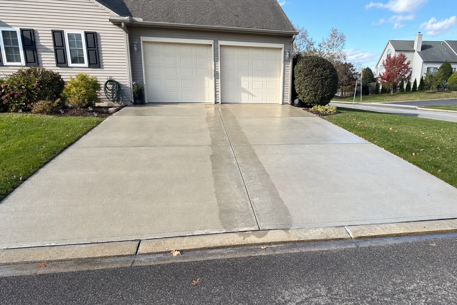 Same driveway uniformly bright after pressure-washing
