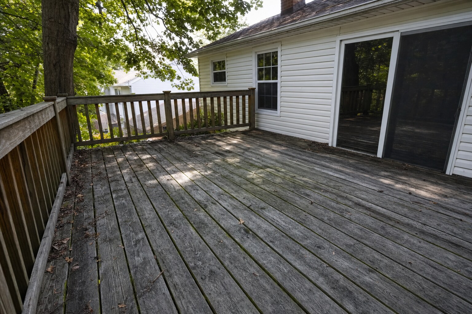 Weathered gray pine deck with mildew before cleaning